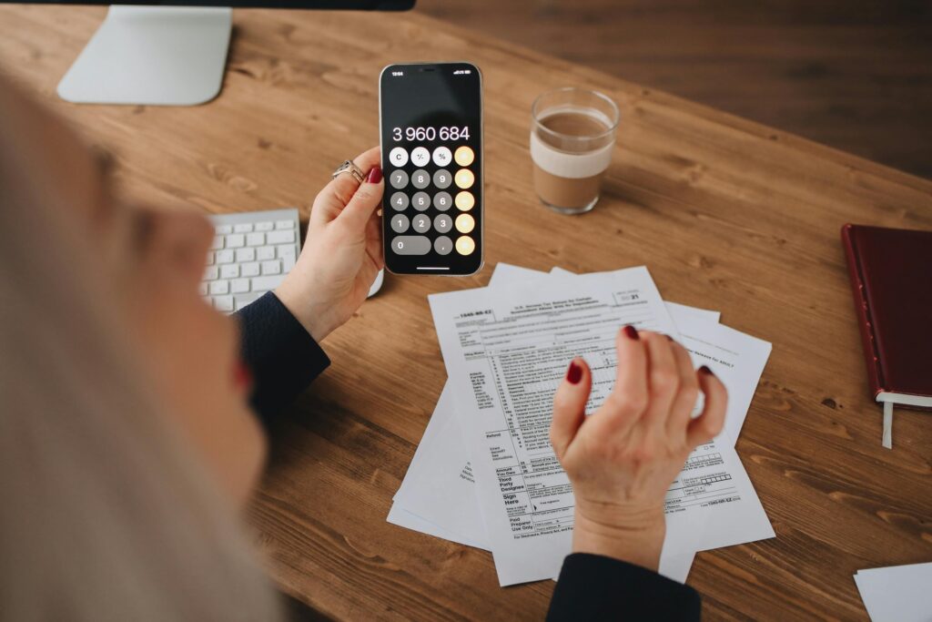 a person holding a calculator and doing taxes