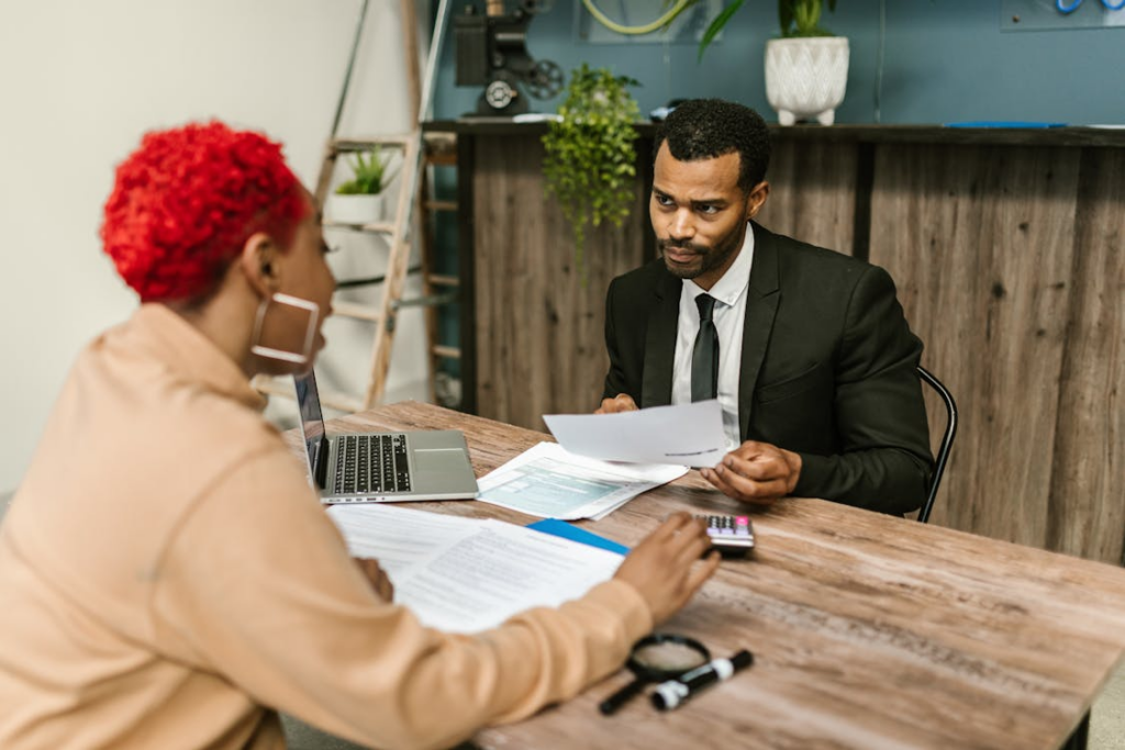 accountant discussing financial records with a business owner during a meeting