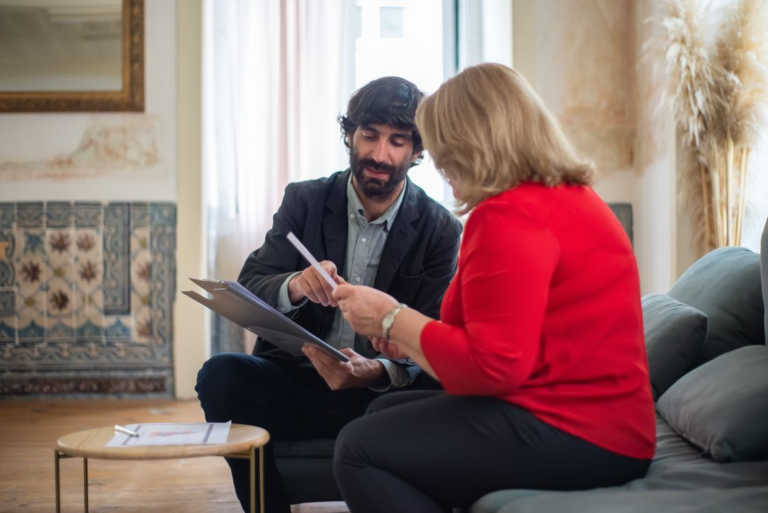 Tax professional discussing documents with a client in an office