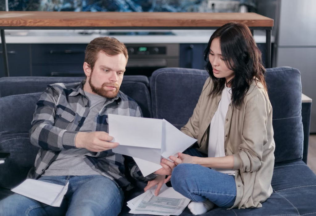 Couple reviewing tax documents and financial paperwork together